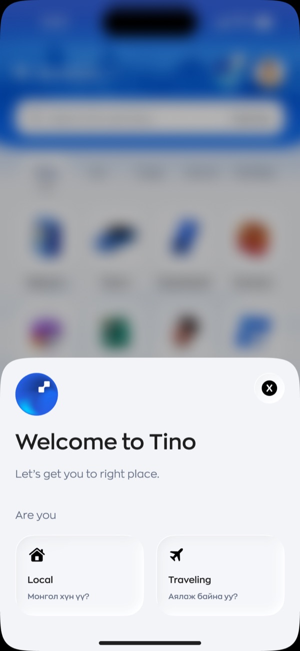 A welcome sheet over a blurred home screen. It reads welcome to Tino, let's get you to right place, then asks are you, with two cards: Local with a house icon, and Traveling with a plane icon, each with a Mongolian subtitle.